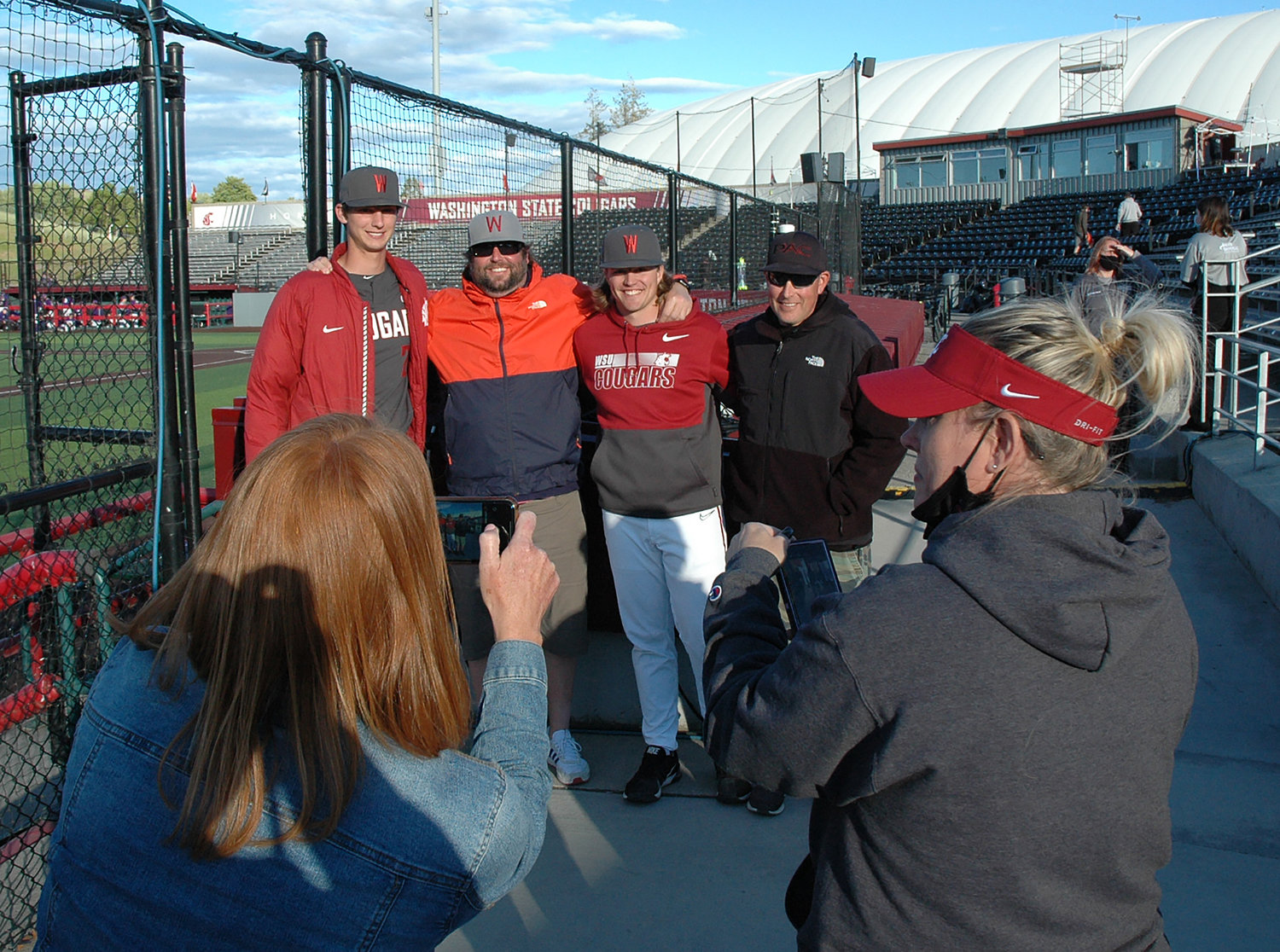 From left, Brandon White, Jason Kelley, Dakota Hawkins, and Bryan Bullock pose for a photo in Pullman after Washington State's game against the University of Washington on May 29. White and Hawkins were teammates at W.F. West High School, where Bullock was the head baseball coach and Kelley was an assistant coach.